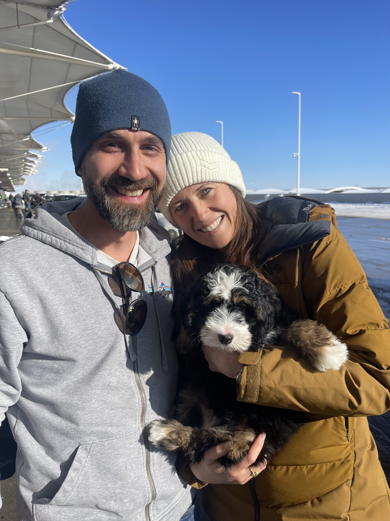 A family holding a newly arrived puppy