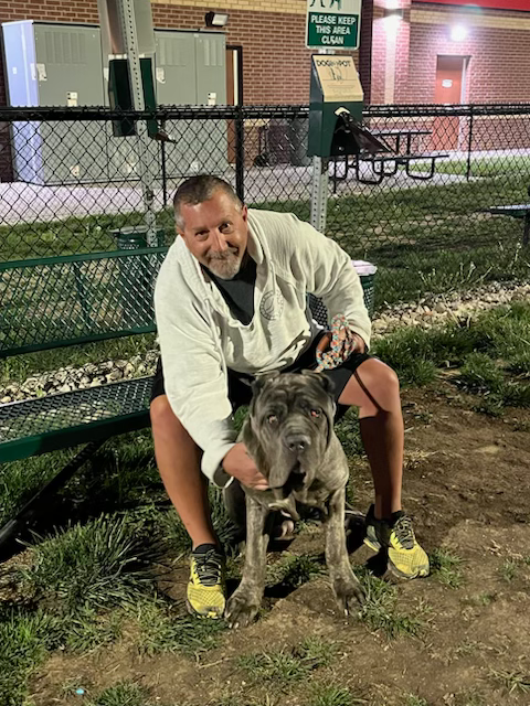 Chris comforting a dog during a supervised travel break