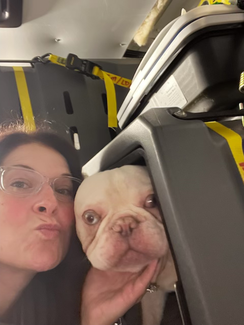 Jennifer with a pet inside the transport vehicle