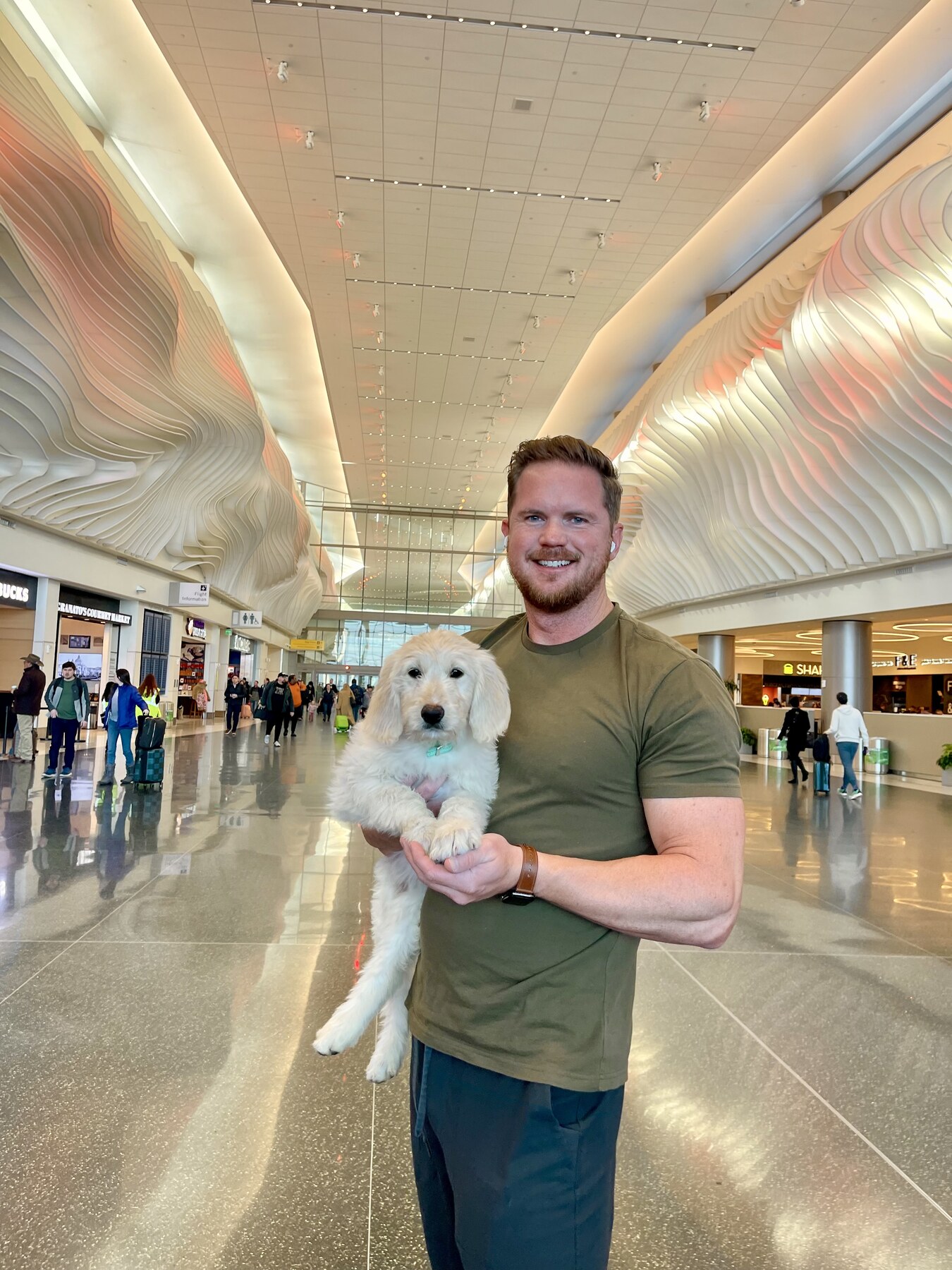 John, Pet Commute CEO and owner, holding a dog in an airport